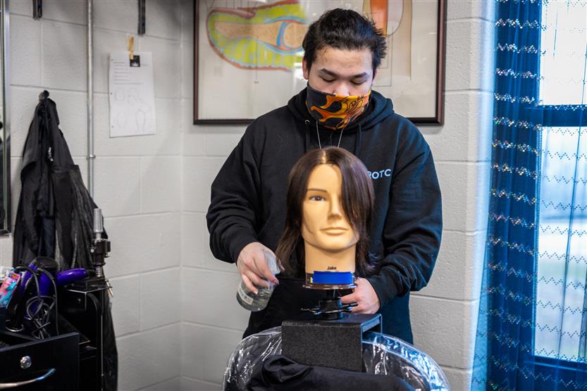 Centennial High students in the cosmetology class